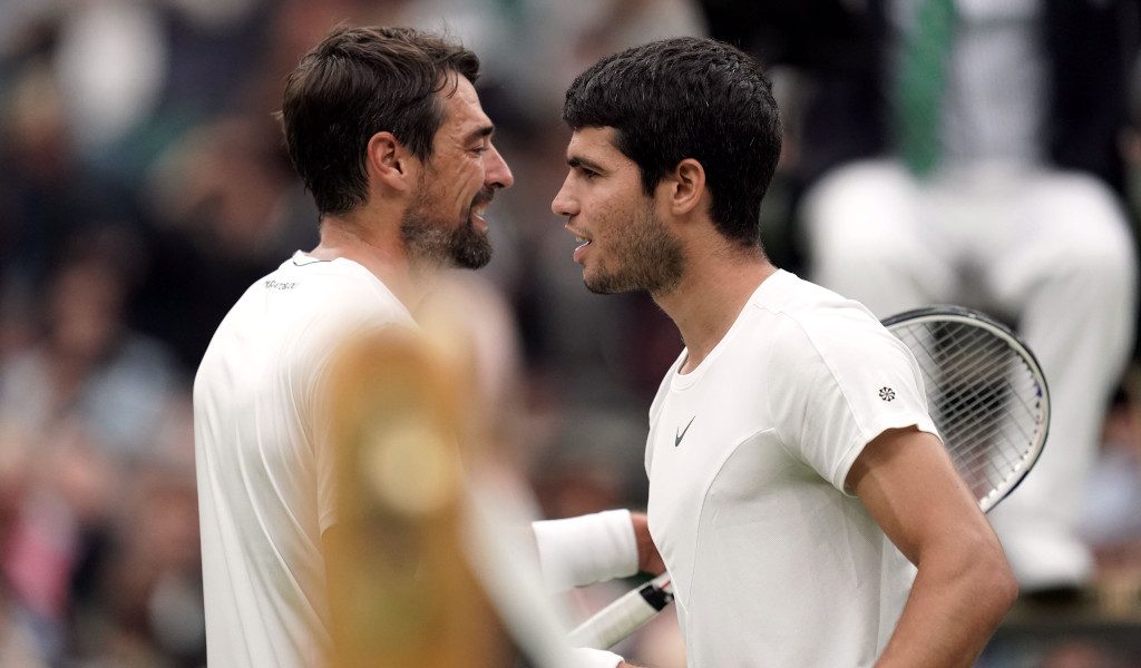 Carlos Alcaraz and Jeremy Chardy (left) embrace at the net after their match on day two of the 2023 Wimbledon Championships at the All England Lawn Tennis and Croquet Club in Wimbledon. Picture date: Tuesday July 4, 2023.